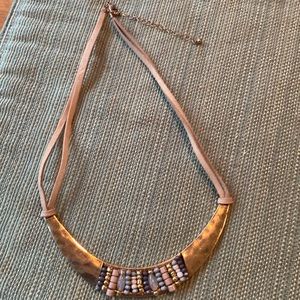 Unique bead, metal, and leather necklace.